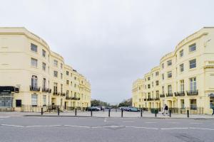 a couple of buildings on a street next to a road at Stunning STUDIO Apartment in Hove Minuets away to BRIGHTON BEACH in Brighton & Hove
