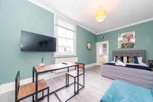 a living room with a couch and a table at Stunning STUDIO Apartment in Hove Minuets away to BRIGHTON BEACH in Brighton & Hove