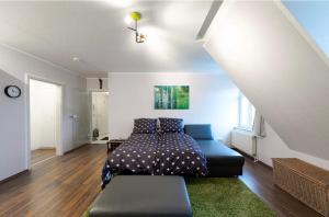 ein Schlafzimmer mit einem Bett und einem Sofa darin in der Unterkunft Altstadt Lennep - Schicke Wohnung in Remscheid