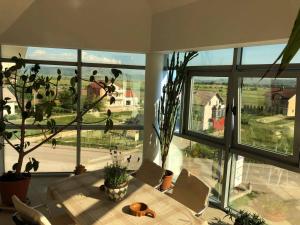 a dining room with a table and a large window at Apartman Tomislav in Tomislavgrad