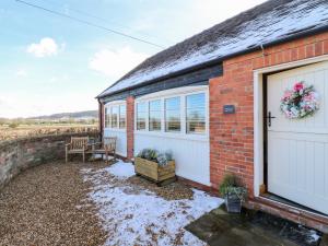 a red brick house with a white garage at Little Gem in Uttoxeter