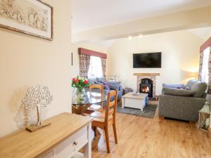 a living room with a table and a dining room at Little Gem in Uttoxeter