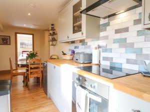 a kitchen with a counter and a dining room at Little Gem in Uttoxeter