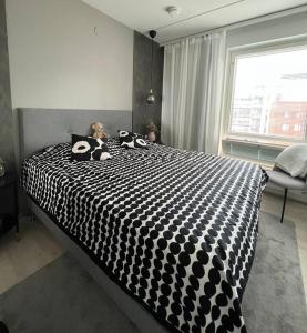 einem Hund, der in einem Schlafzimmer auf einem Bett sitzt in der Unterkunft New condo with free parking 10 min from Helsinki Airport in Vantaa