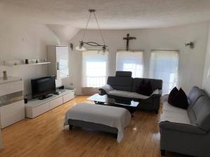 a living room with a couch and a tv at Apartman Tomislav in Tomislavgrad