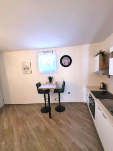 a kitchen with a table and chairs in a room at Kupinica Apartment in Vinišće +10 photos