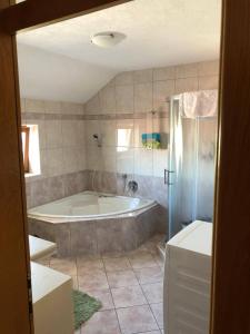 a large bathroom with a tub and a shower at Apartman Tomislav in Tomislavgrad +37 photos