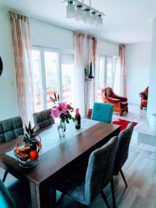 a living room with a wooden table and chairs at Holiday home Buljat in Kaštela