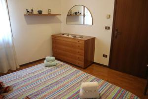 a bathroom with a sink and a dresser and a rug at Casa Angela a Follina in Follina