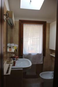 a bathroom with a sink and a window at Casa Angela a Follina in Follina