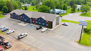 an aerial view of a building with cars parked in a parking lot at Hibbing Inn & Suites in Hibbing