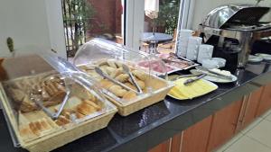 a counter with baskets of pastries on it at Hotel Diego De Almagro Talca in Talca