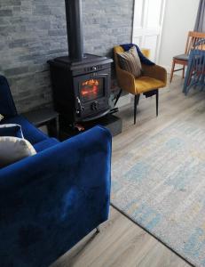 a living room with a stove and a couch at Glenhill - Newly renovated in a unique location in Belmullet