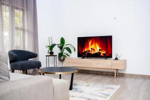 a living room with a fireplace in the wall at Golfview luxury apartment in Richards Bay