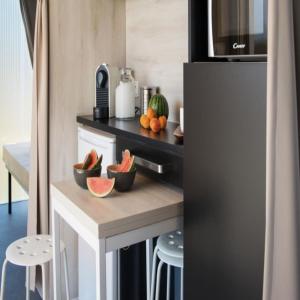 a kitchen with a counter with bowls of fruit on it at Pet Family Camping Cortina in Senigallia