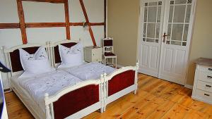 a bedroom with a white bed with white pillows at Spree Chalet - adults only in Lübbenau