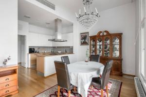 a kitchen and dining room with a table and chairs at Spacious Home With four Terrace, Sauna, Sea View in Helsinki