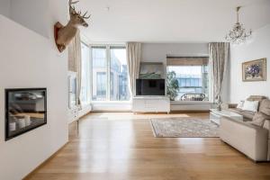 a white living room with a deer head on the wall at Spacious Home With four Terrace, Sauna, Sea View in Helsinki