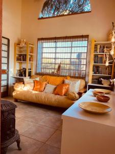 a living room with a couch and a window at Morada de encuentro in Capilla del Monte