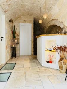 a living room with a tile floor and a door at PALAZZO CAVÌ in Mola di Bari