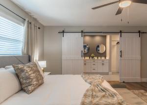 a bedroom with a white bed and a ceiling fan at Lake House Retreat Near Downtown, Disney, Universal Studios and Airport in Orlando