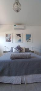 a bedroom with a large bed in a white room at DOLCE LUNA in Roldán