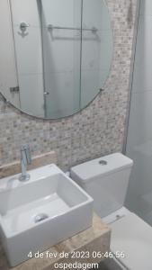 ein Badezimmer mit einem WC, einem Waschbecken und einem Spiegel in der Unterkunft Lar Jampa - Casa para Temporada in João Pessoa