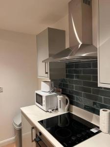 a kitchen with a microwave and a stove top oven at 011- One bedroom in Ealing F3 in Ealing
