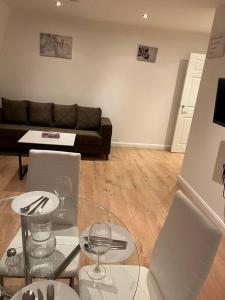 a living room with a glass table and a couch at 011- One bedroom in Ealing F3 in Ealing