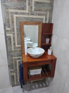 a bathroom with a sink and a mirror at costanera departamento in Viedma +3 photos
