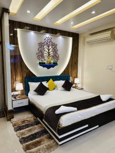 a bedroom with a large bed with a large painting on the wall at Hotel Buddha International in Patna