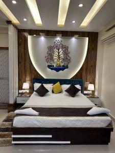 a bedroom with a large bed with a large orb above it at Hotel Buddha International in Patna