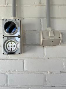 a brick wall with a toaster and a cell phone at Benson House & Benson Lodge in Benalla