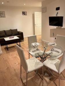 a living room with a glass table and chairs at 009- Studio apartment in Ealing F5 in Ealing