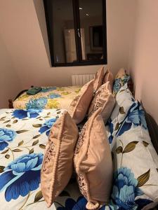 a bed with pillows on it in a bedroom at 009- Studio apartment in Ealing F5 in Ealing