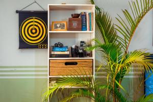 a book shelf in a room with a plant at PALM Springs Bed & Breakfast in Limbe