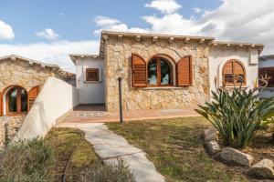 a stone house with a pathway in front of it at Vista Mare Apartment 5 in Olbia +7 photos