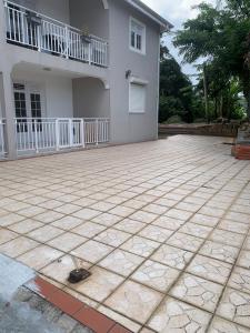 a patio in front of a white house at StephAppart in Le Robert