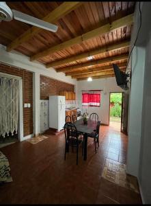a kitchen and dining room with a table and chairs at Cabañas Dorys Cataratas Del Iguazu in Puerto Iguazú