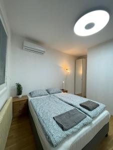 a bedroom with a bed with a blue comforter at Nice rooftop hostel in Vienna