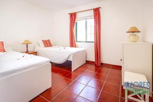 מיטה או מיטות בחדר ב-Porto Tranquilo