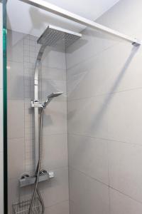 a shower with a shower head in a bathroom at Swallow Cottage in Bridgend +46 photos