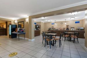 a dining room and kitchen with tables and chairs at Best Western Colonial Inn in Selma