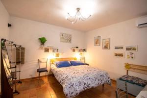 a bedroom with a bed and a chandelier at Alloggio turistico Maria Paola in Tarquinia