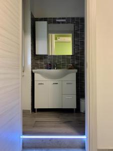 a bathroom with a white sink and a mirror at L.ADY HOME in Bologna