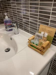 um lavatório de casa de banho com uma bandeja de sabão e cosméticos em L.ADY HOME em Bolonha