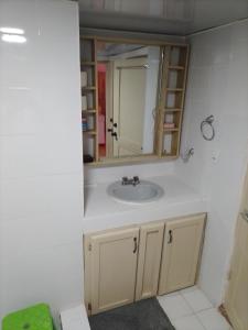 a bathroom with a sink and a mirror at Lavish Condo @Carlos Residential in Sosúa