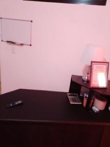 a room with a table with a lamp and a bed at Lavish Condo @Carlos Residential in Sosúa