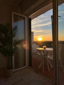 a balcony with a table and a view of the sunset at Lagos Apartment Sea View in Lagos +18 photos