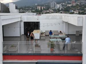 a group of people standing on the roof of a building at Wabi Salvi Apartment-A senses experience. in San Salvador